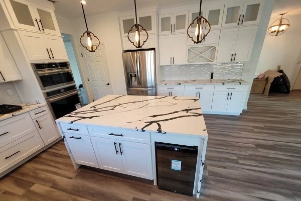 Modern kitchen renovation with white cabinets and island
